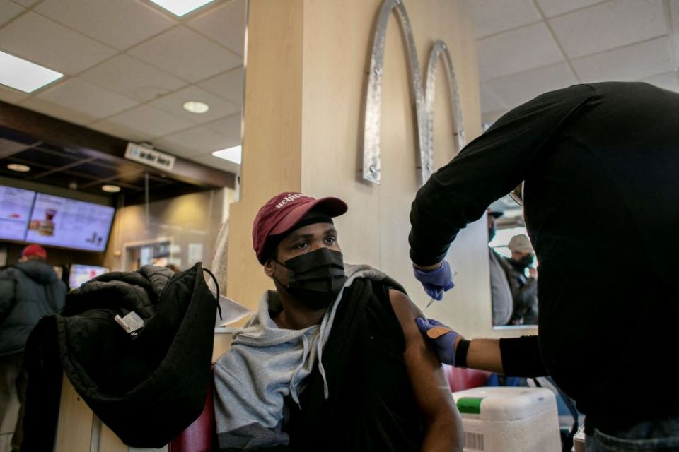 A man in Chicago receives a COVID-19 booster shot at a McDonald's Dec. 21. (CNS/Reuters/Jim Vondruska)