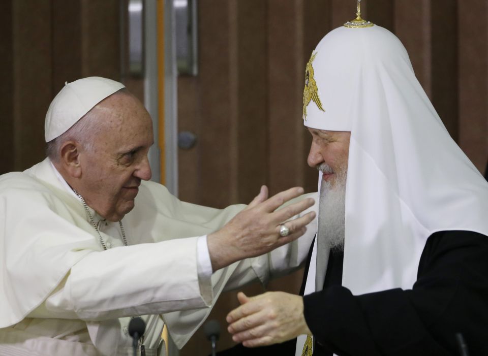 Pope Francis, left, reaches to embrace Russian Orthodox Patriarch Kirill after signing a joint declaration at the Jose Marti International airport in Havana, Cuba, Friday, Feb. 12, 2016. (AP Photo/Gregorio Borgia, Pool, File)