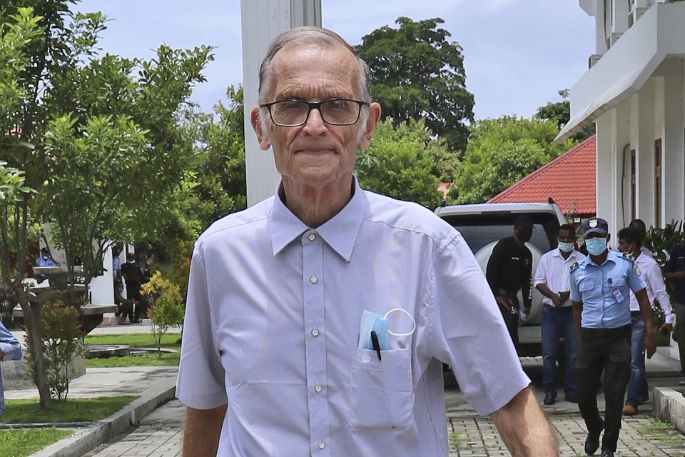 Richard Daschbach, a former missionary from Pennsylvania, is escorted by a police officer upon his arrival for a trial at a courthouse in Oecusse, East Timor on Feb. 23, 2021. (AP Photo/Raimundos Oki, File)