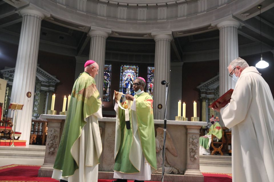 Dublin Archbishop Dermot Farrell receives his pallium from Archbishop Jude Thaddeus Okolo, papal nuncio, center, at St. Mary's Pro Cathedral in Dublin Aug. 7, 2021. (CNS photo/courtesy John McElroy)