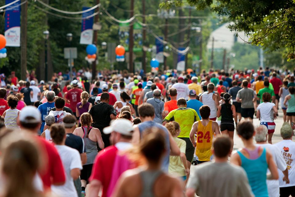 The Peachtree Road Race in pre-pandemic years: Thousands of runners crowd an Atlanta street on their way to the Peachtree finish line on July 4, 2014. (Dreamstime/Russ Ensley)