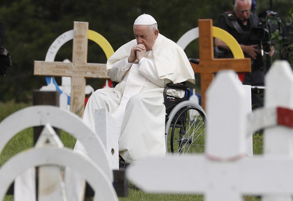 Pope Francis prays at the Ermineskin Cree Nation Cemetery before meeting with First Nations, Métis and Inuit communities July 25 at Maskwacis, Alberta. (CNS/Paul Haring)