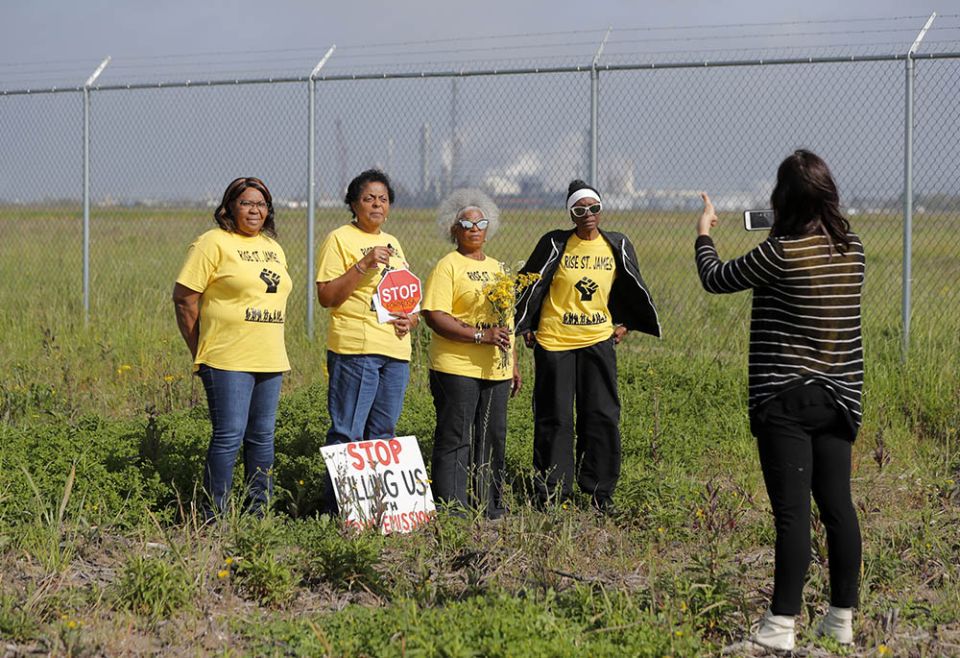 Members of Rise St. James conduct a livestream video on property owned by Formosa Plastics Group in St. James Parish, Louisiana, on March 11, 2020. (AP/Gerald Herbert)
