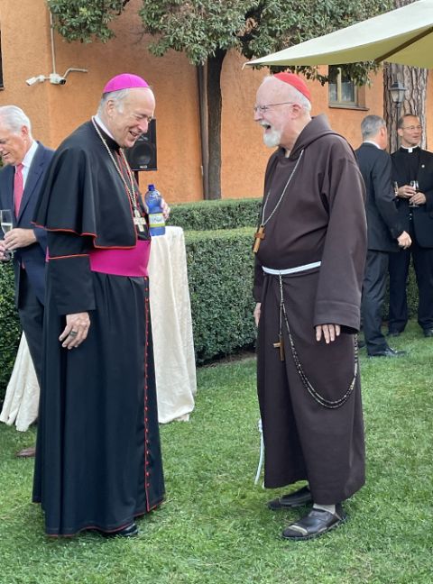Cardinals Robert McElroy and Sean O'Malley speak during a reception hosted by the U.S. embassy to the Holy See on Aug. 26. (Courtesy of Paulist Sr. Rose Pacatte)